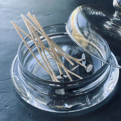 4. Close-up of Candledust extra wicks in a glass container, featuring 10 pieces with sustainers