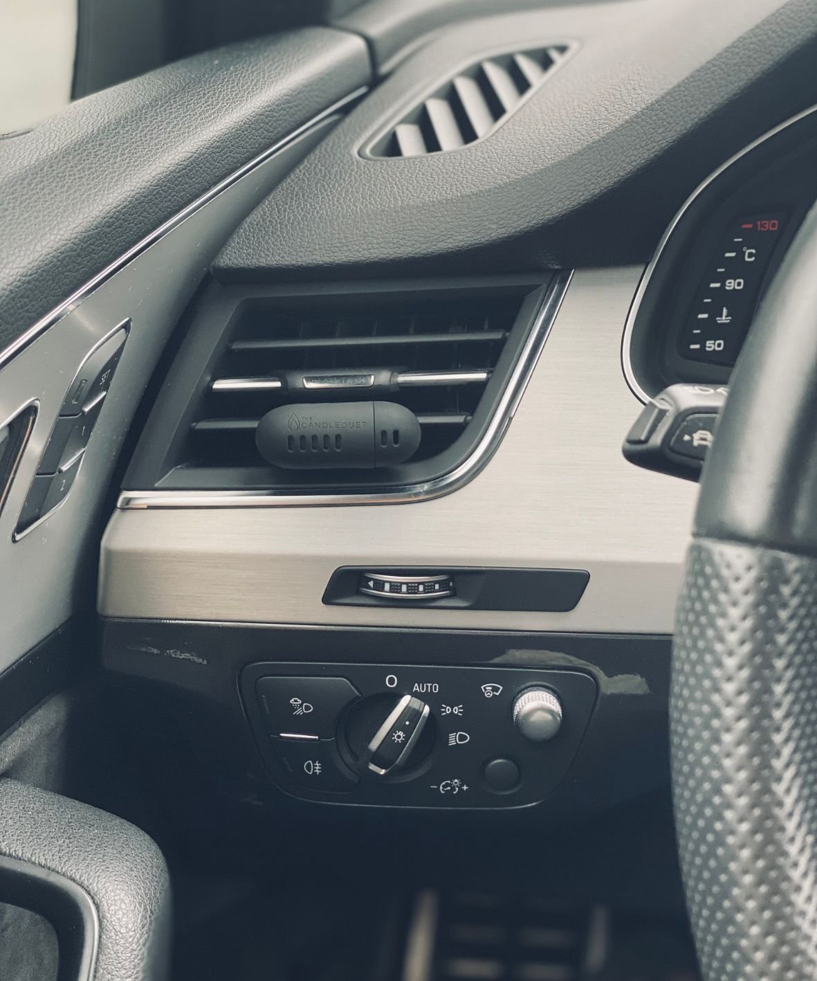3. Candledust Signature car diffuser on car dashboard, highlighting sleek style