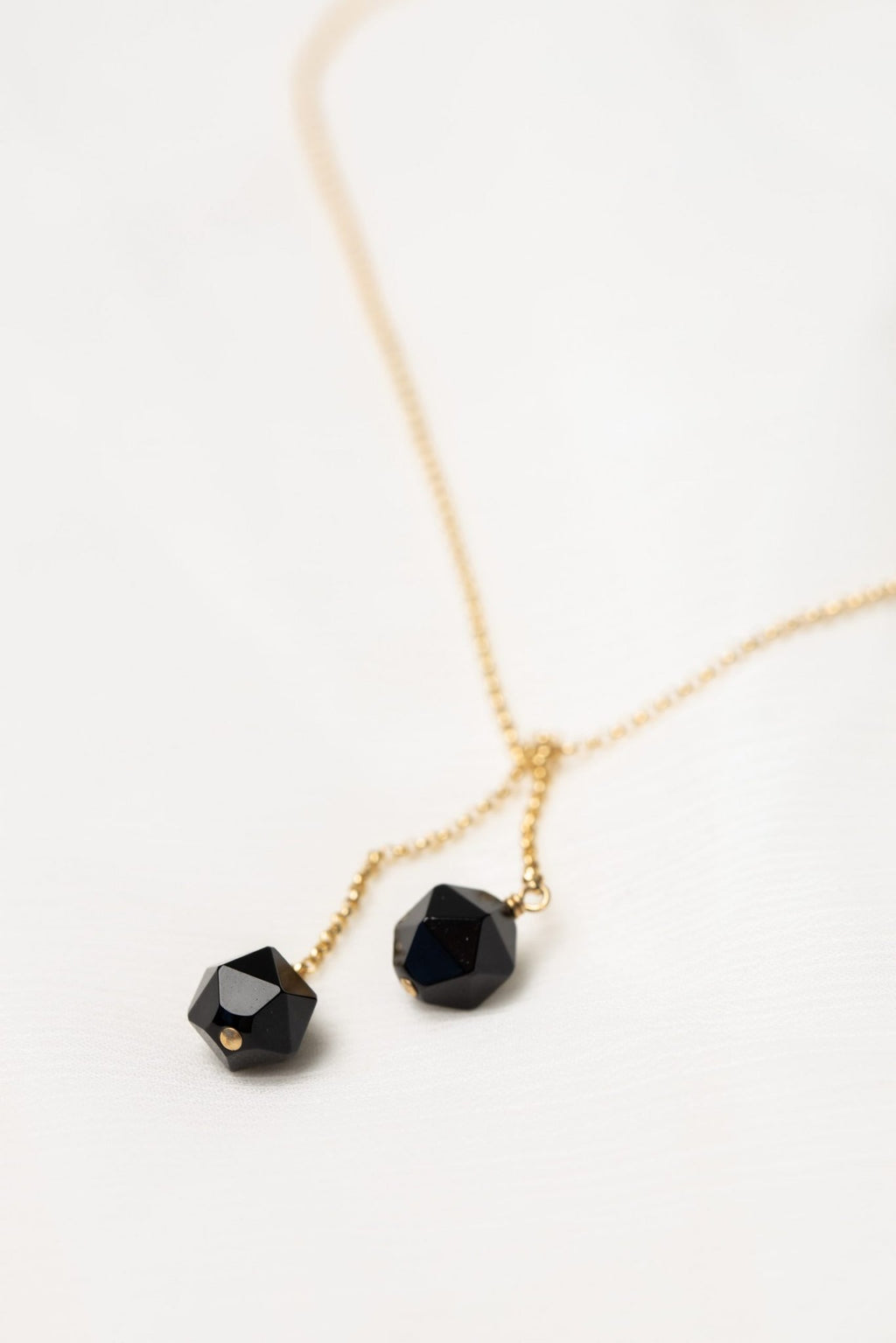 3. Close-up of Tied To Coco - Onyx necklace by New Vintage by Kriss, highlighting faceted onyx stones and gold-filled chain