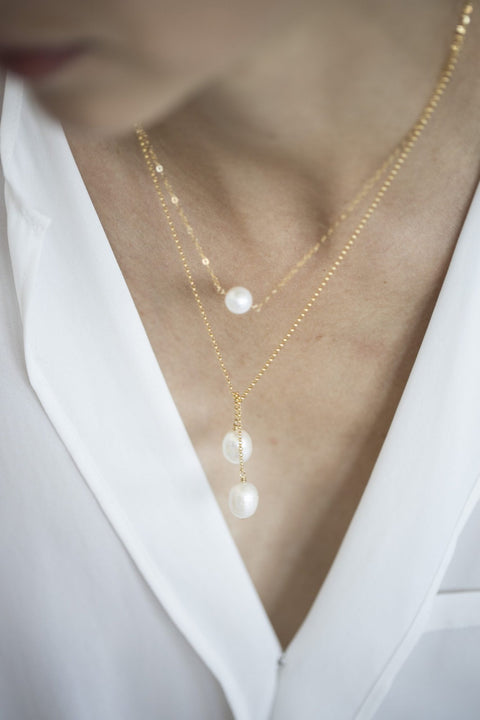 1. Women's TIED TO COCO - Pearl necklace by New Vintage by Kriss, featuring two large pearls on a gold-filled chain, worn with a white blouse