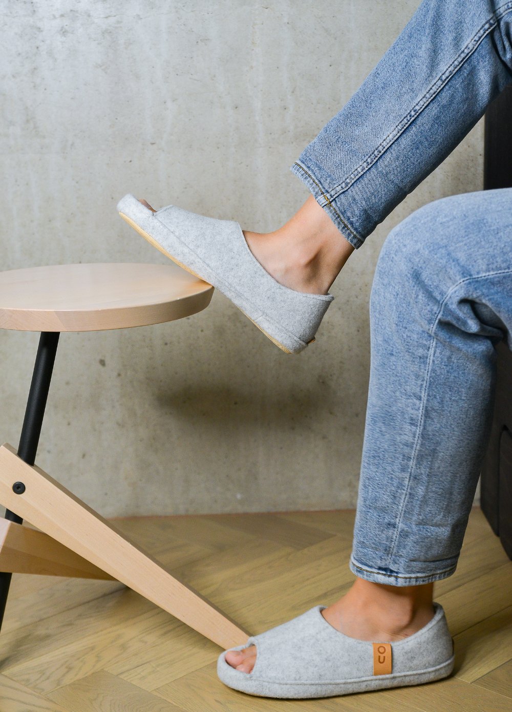 1. Unisex TOKU Bern white slippers by Omaking worn by a model in a lifestyle setting, showcasing comfort and style