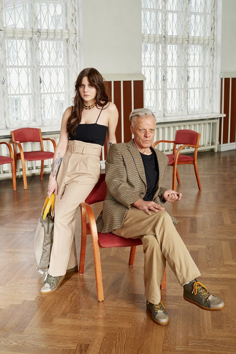 1. Unisex TOKU Stockholm Sneakers in grey worn by male and female models in a stylish indoor setting