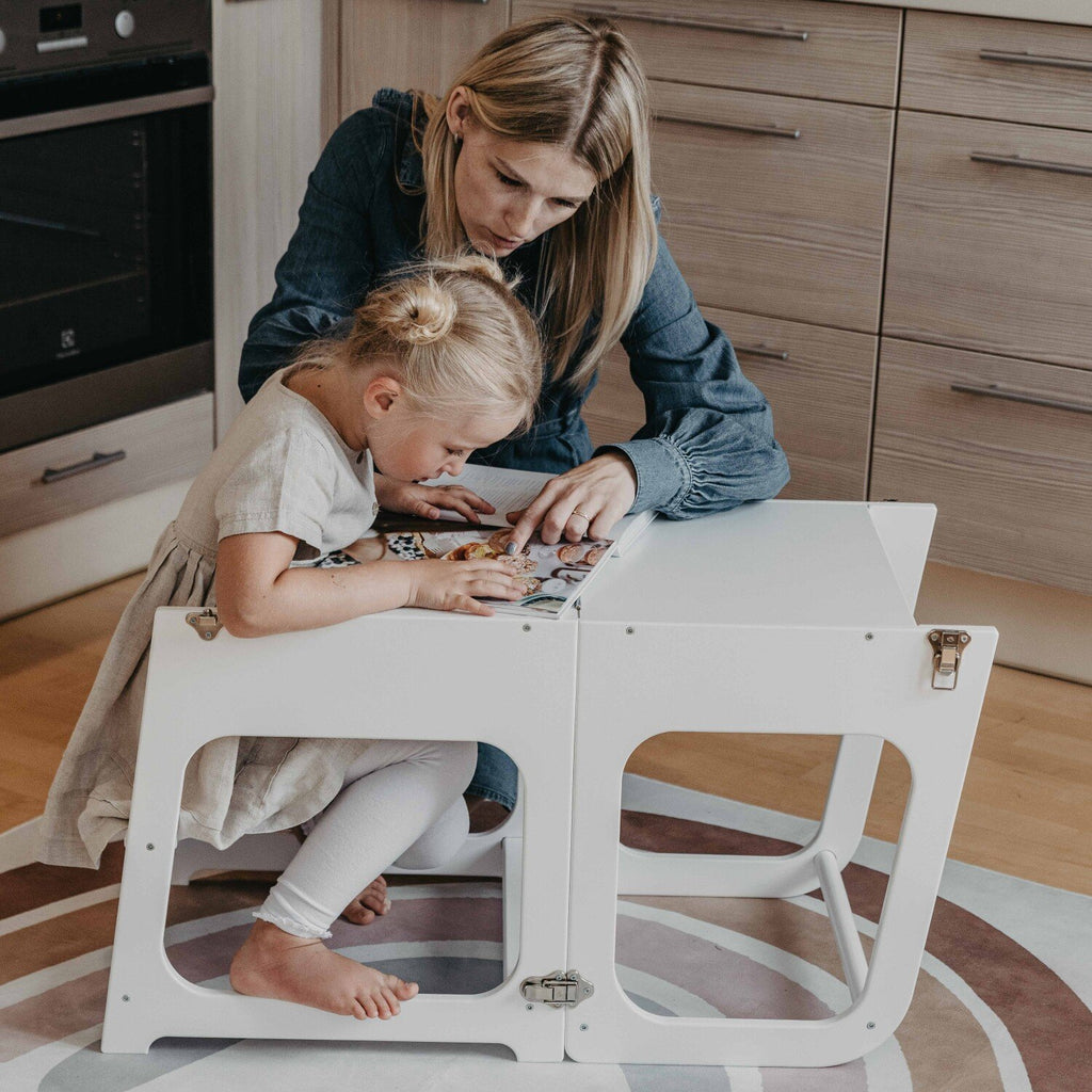 4. Mother and daughter using transformable kitchen tower as table and chair for drawing