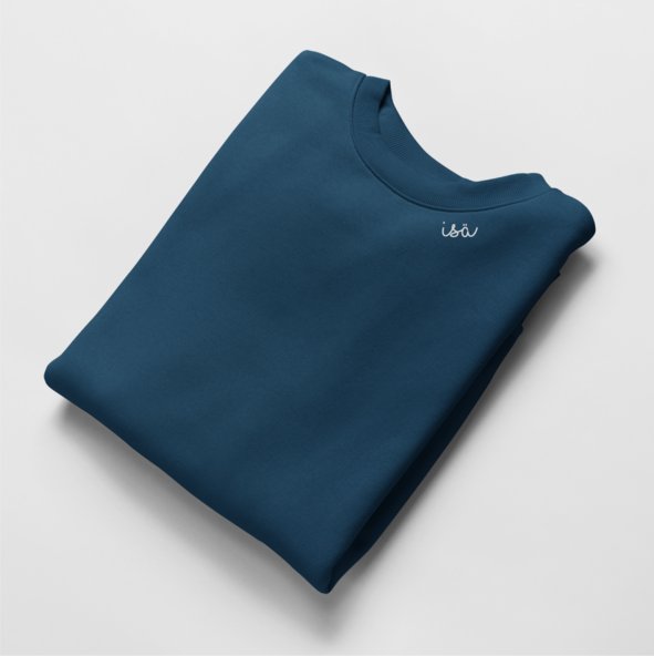 4. Flat lay of navy organic cotton sweatshirt with 'Isä' embroidery, folded neatly