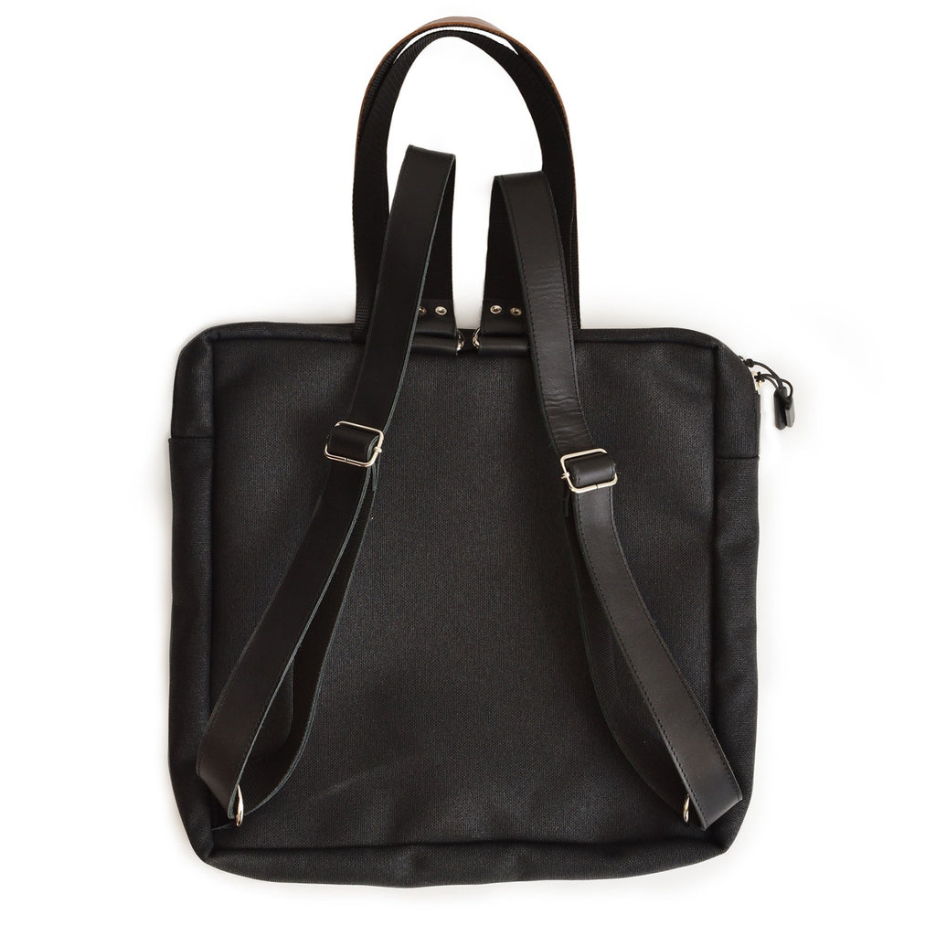 3. Studio image of the Omaking Stockholm Backpack in black, showing the back with adjustable straps and durable fabric