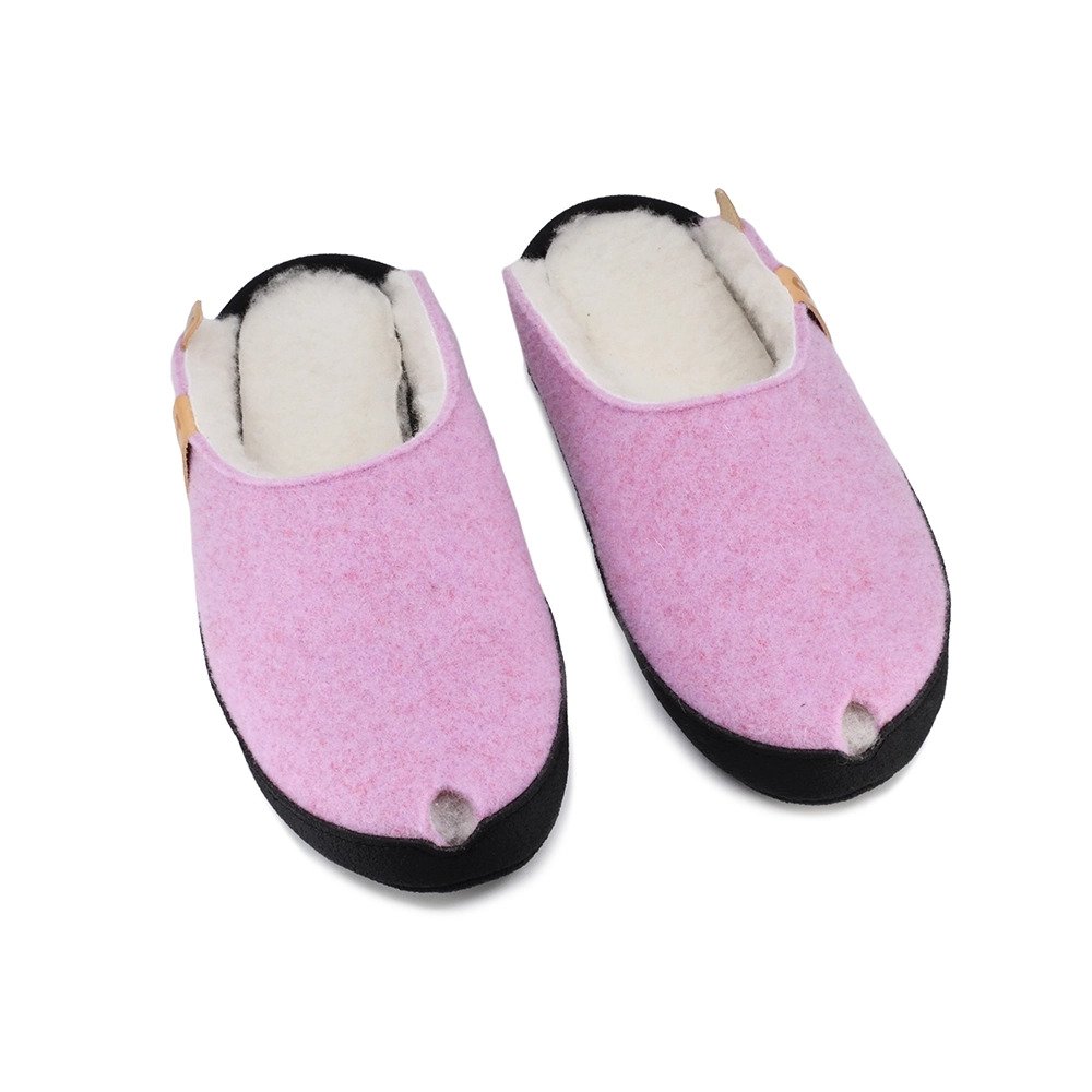2. Studio image of TOKU Brussels slippers in light pink with lambswool lining and black sole