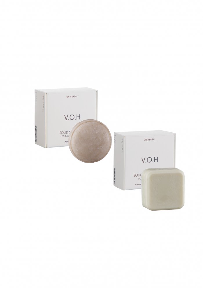 6. V.O.H solid shampoo and conditioner bars on a rustic stool with a bath brush, highlighting sustainable beauty