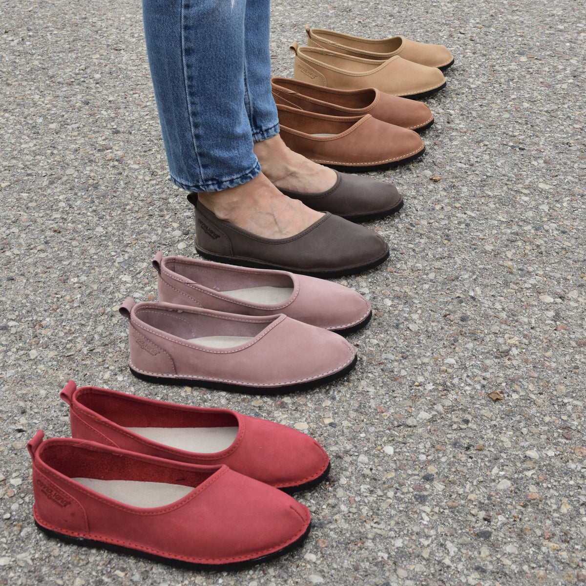 4. Close-up of Omaking Kuutsid shoes in multiple colors, including dark green, red, and brown, on pavement