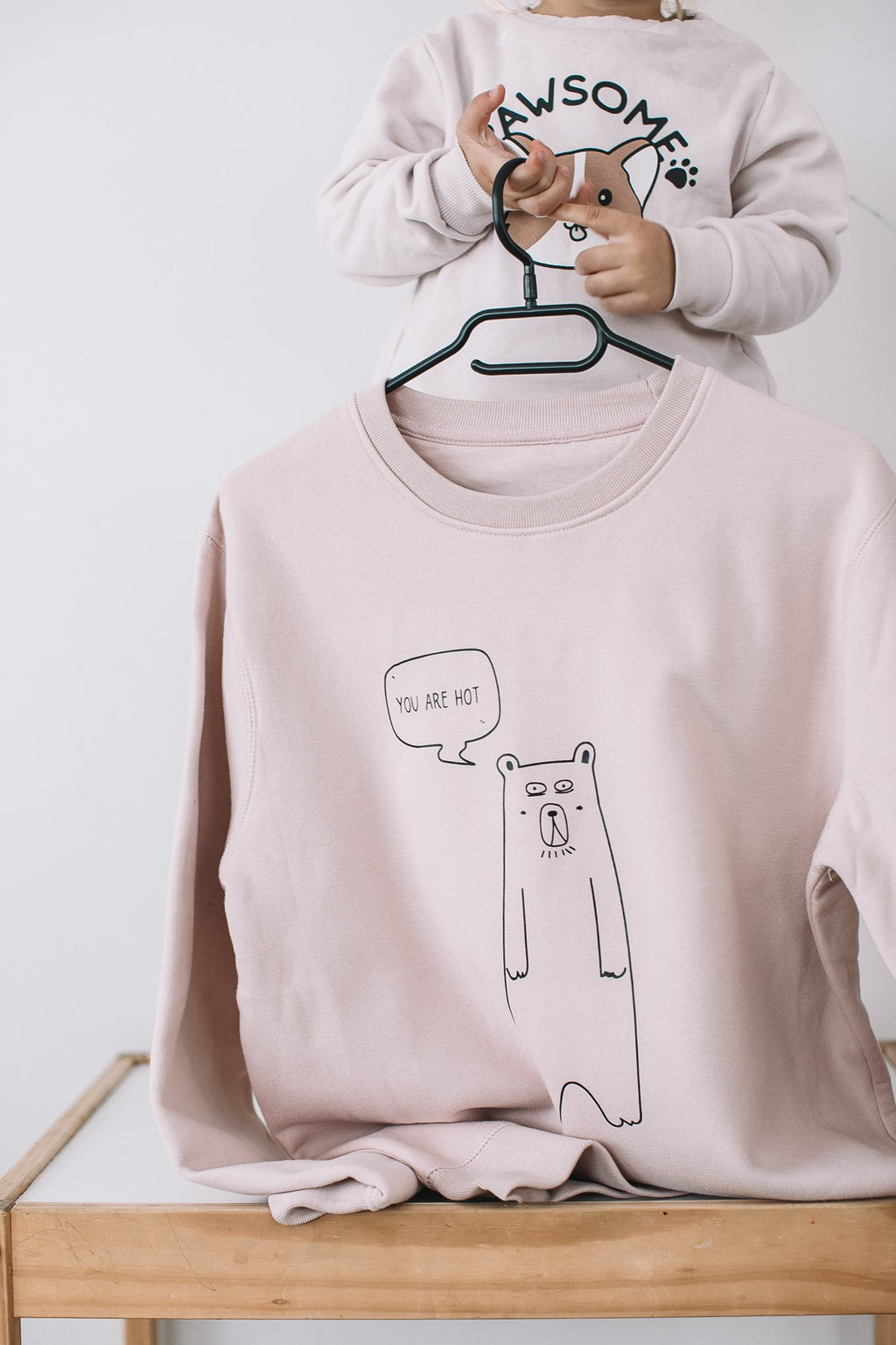 1. Soft Rose oversized sweatshirt by Black Giraffe Brand with 'You are hot' bear graphic, shown on hanger