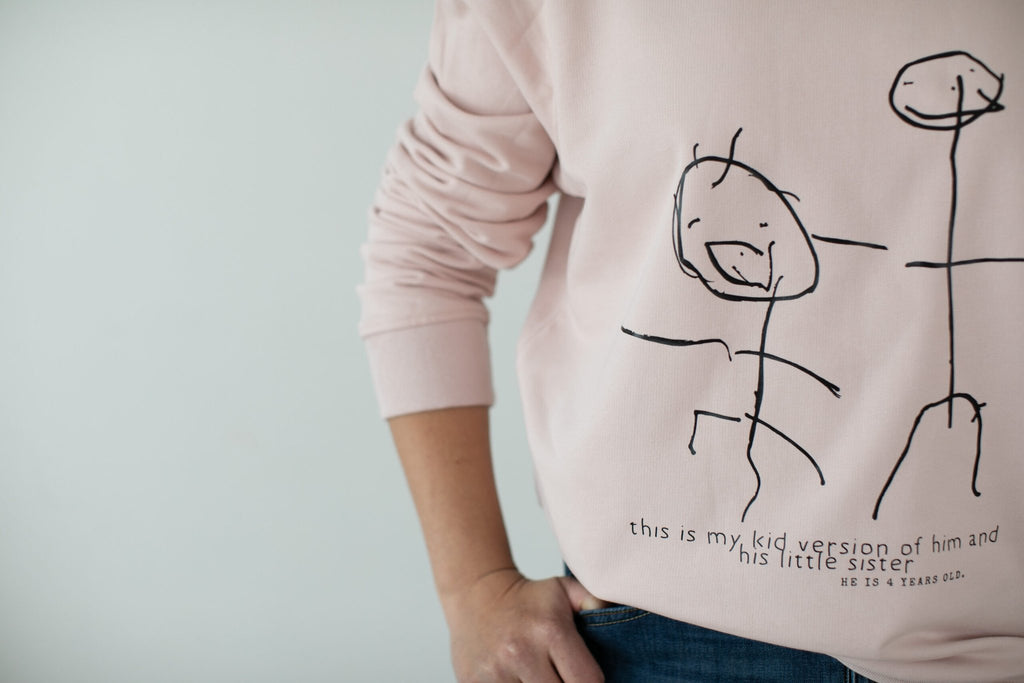 1. Women's soft rose sweatshirt with child's drawing, Black Giraffe Brand, shown in lifestyle setting