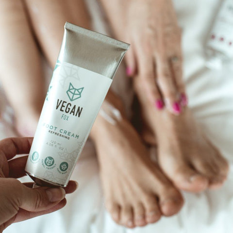 1. Vegan Fox Refreshing Foot Gel held by a person with feet in the background, showcasing product use
