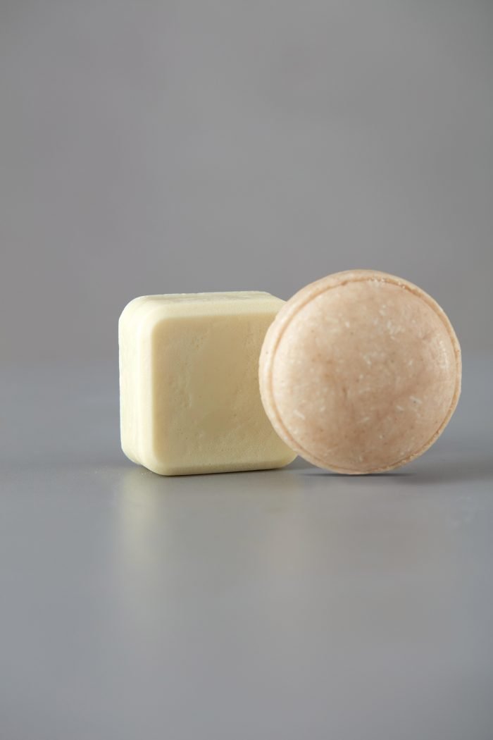 9. V.O.H solid shampoo and conditioner on a neutral background, showcasing minimalist design