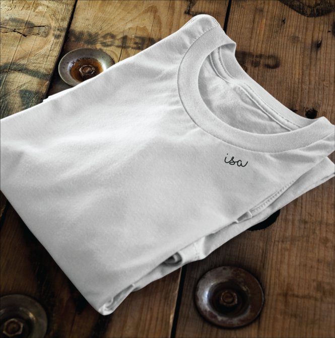 9. Flat lay of white, black, and green organic cotton T-shirts by Beebila, showcasing embroidered collars