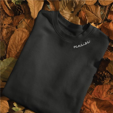 3. Black Vanaisa sweatshirt by Beebila with embroidered collar, displayed on autumn leaves