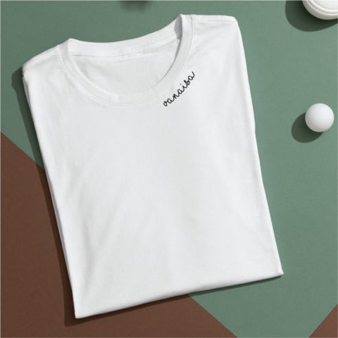 4. Flat lay of white unisex organic cotton t-shirt with embroidered 'Vanaisa' collar