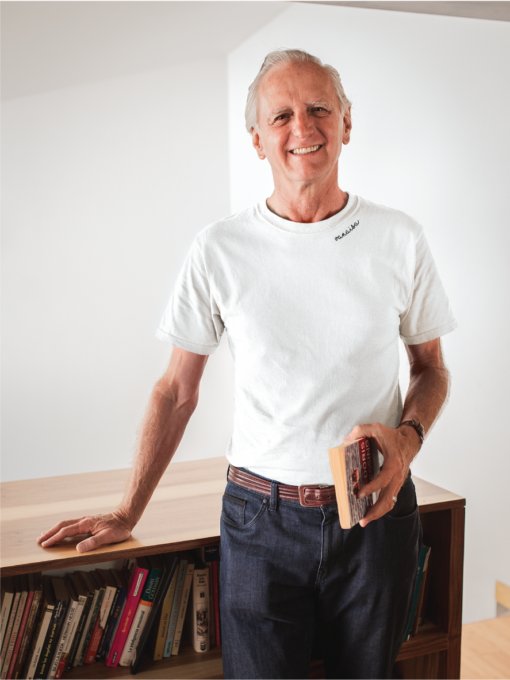 1. Unisex white organic cotton t-shirt with embroidered collar worn by male model in lifestyle setting