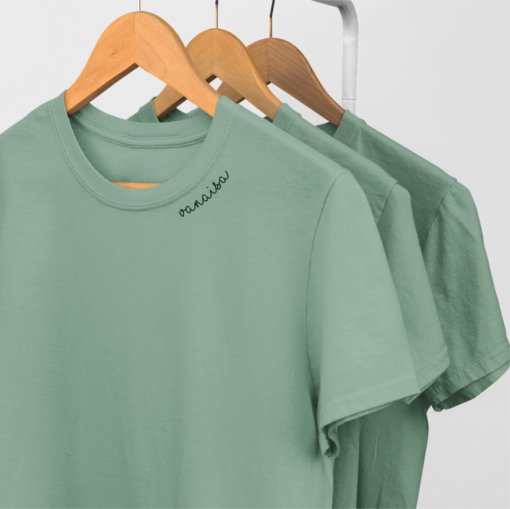 5. Studio shot of green unisex organic cotton t-shirts with embroidered 'Vanaisa' collar on hangers