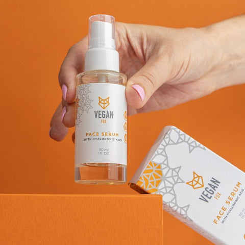 1. Vegan Fox Face Serum with Hyaluronic Acid, 30 ml, held by a hand, showcasing packaging design