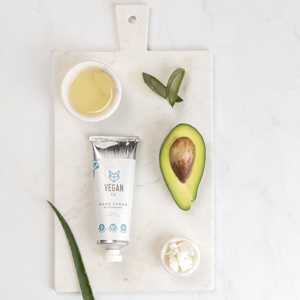8. Vegan Fox Hand Cream with avocado and aloe on a marble board, showcasing natural ingredients