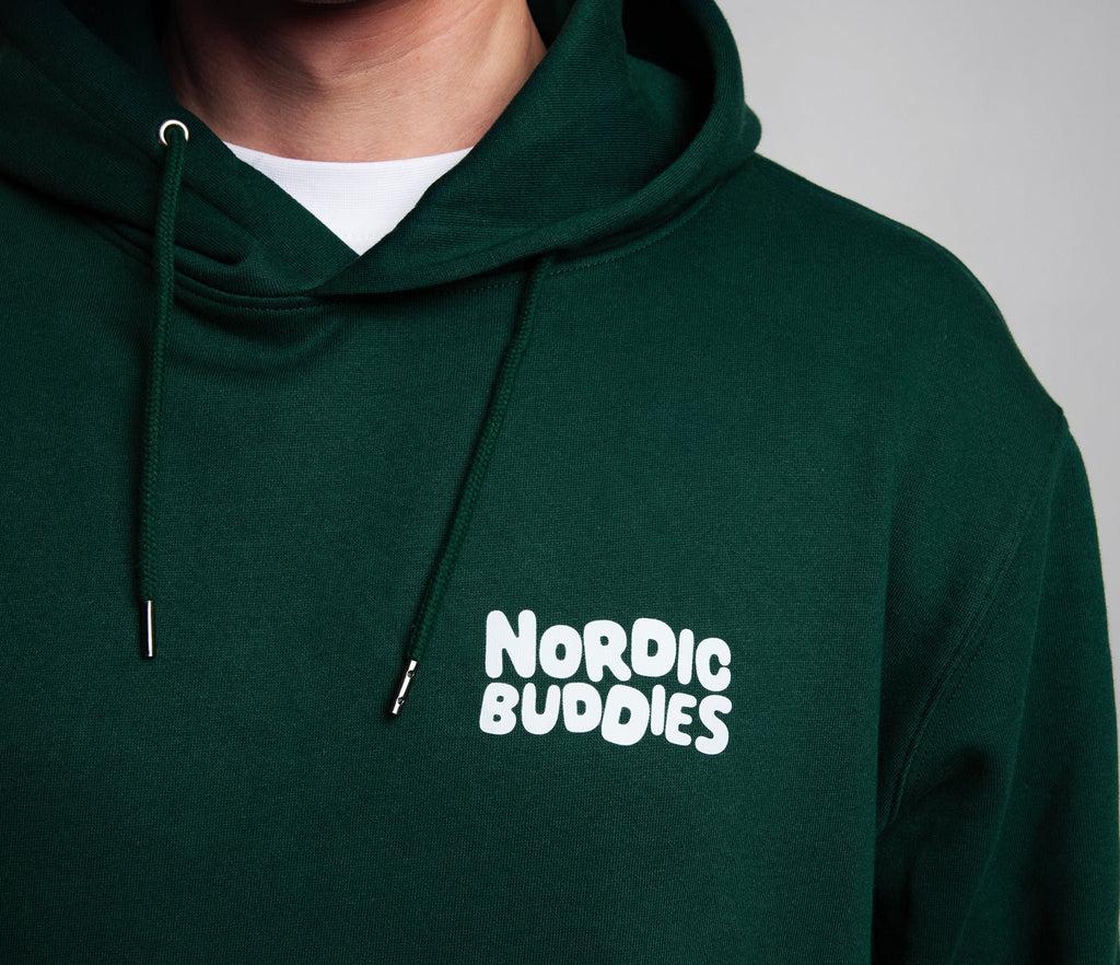 5. Close-up of Nordic Buddies logo on green Moomin hoodie, highlighting fabric texture