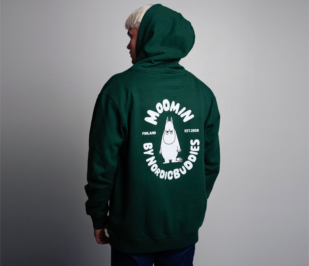 1. Unisex green Moomin hoodie worn by male model, showcasing back design with Moomin character in studio setting