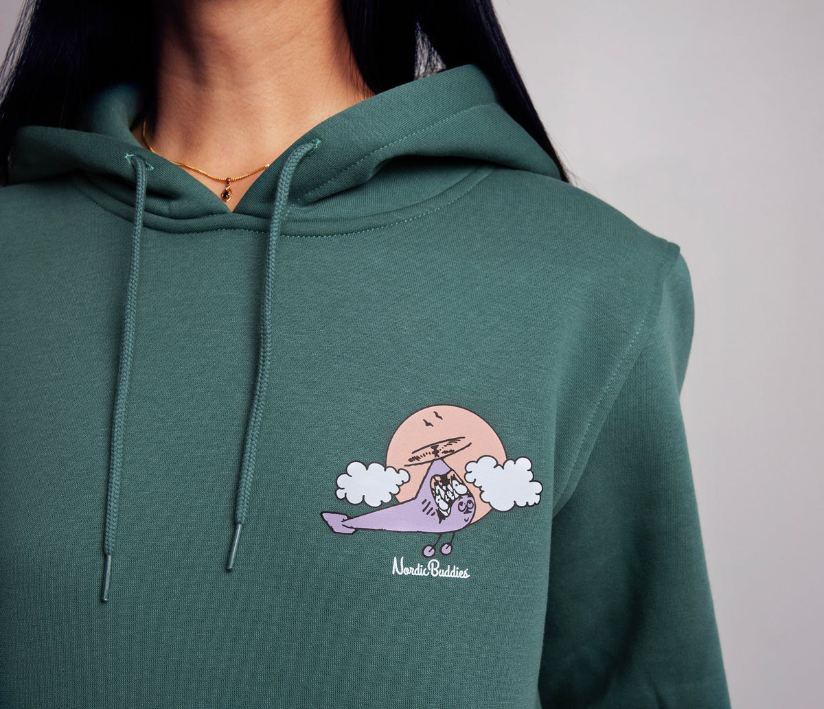 3. Close-up of green Moomin by NordicBuddies hoodie with Moominhouse graphic on chest