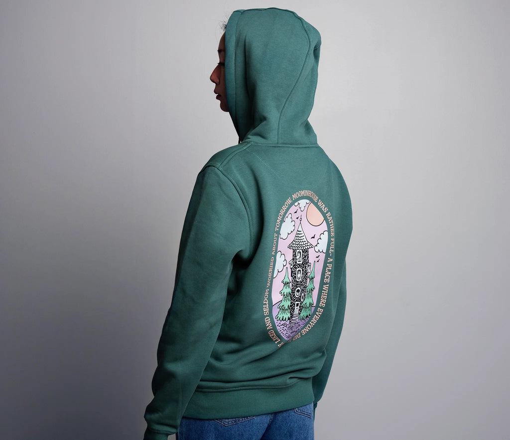 2. Women's green Moomin by NordicBuddies hoodie showing back Moominhouse design, worn by model
