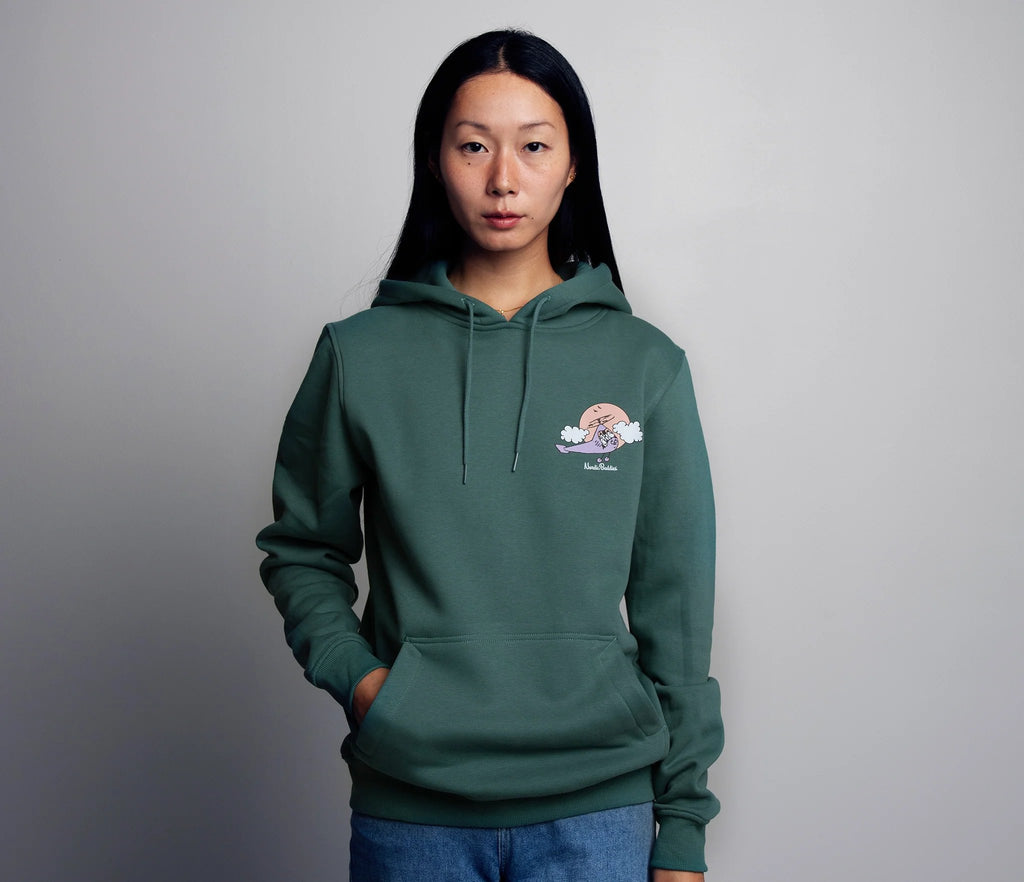 1. Women's green Moomin by NordicBuddies hoodie with Moominhouse design, worn by model in studio