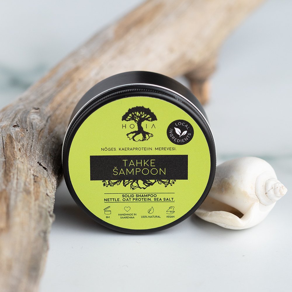 1. HOIA homespa solid shampoo in eco-friendly metal tin, featuring nettle, oat protein, and sea salt, shown with natural elements