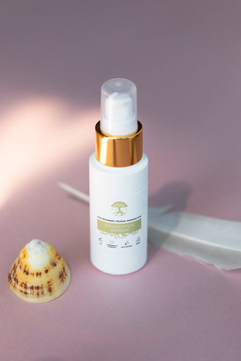 1. HOIA homespa hair serum for split ends, 50ml bottle with gold cap, styled with a shell and feather on a pink background