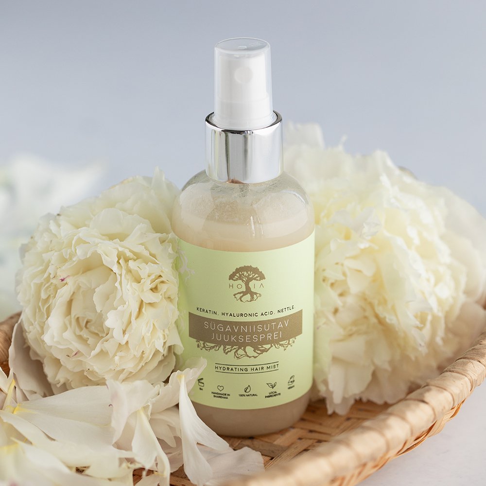 2. HOIA homespa Deep Moisturising Hair Spray 100ml in a basket with white flowers, highlighting natural ingredients