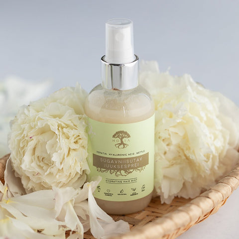 2. HOIA homespa Deep Moisturising Hair Spray 100ml in a basket with white flowers, highlighting natural ingredients
