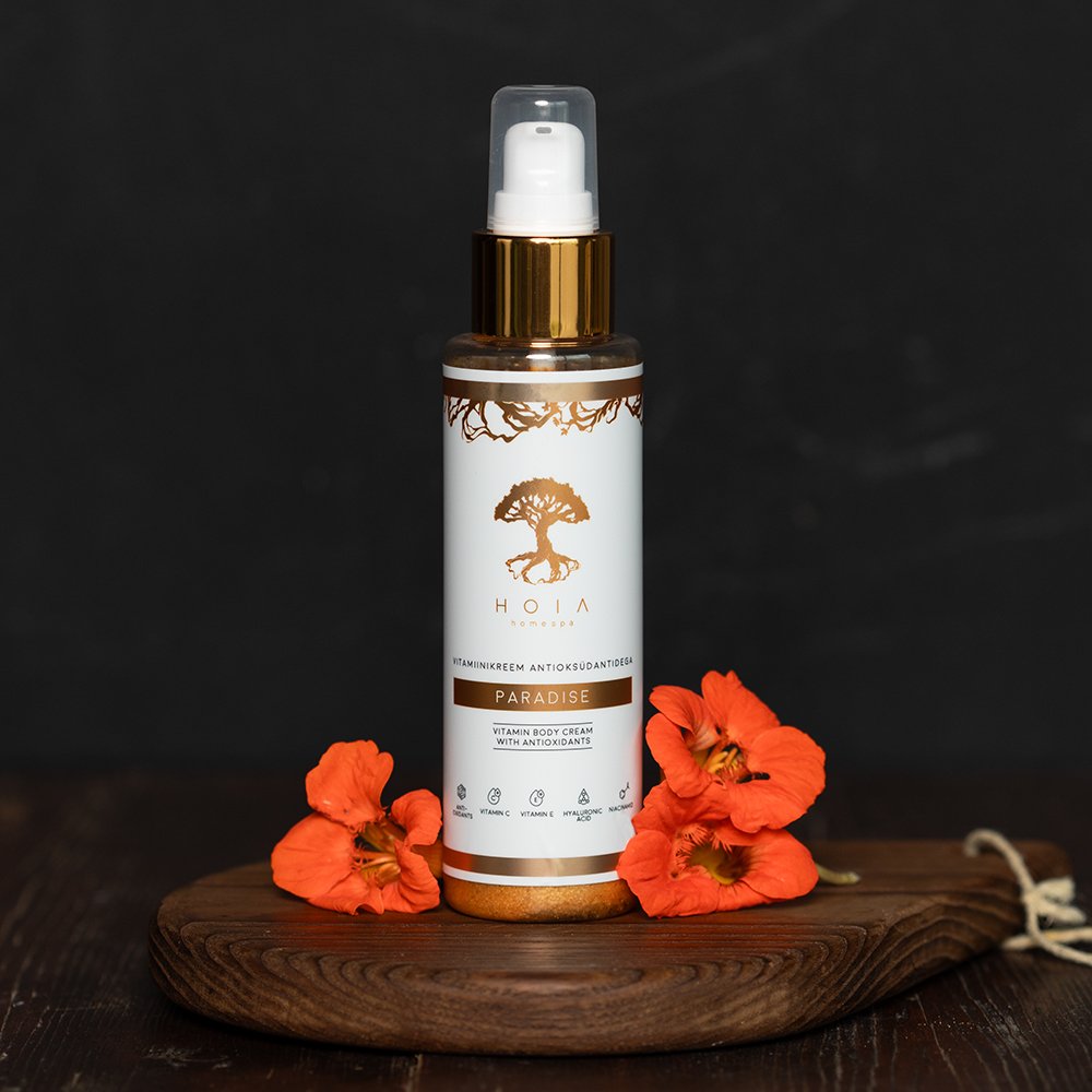 2. HOIA homespa Vitamin Body Cream Paradise, 100 ml, displayed on wooden board with orange flowers, highlighting luxurious packaging