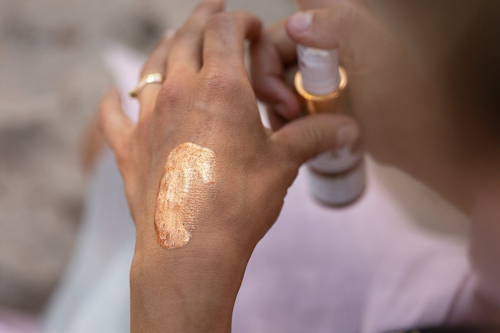 3. Woman holding HOIA homespa Body Cocktail Body Glam near poolside, emphasizing product packaging