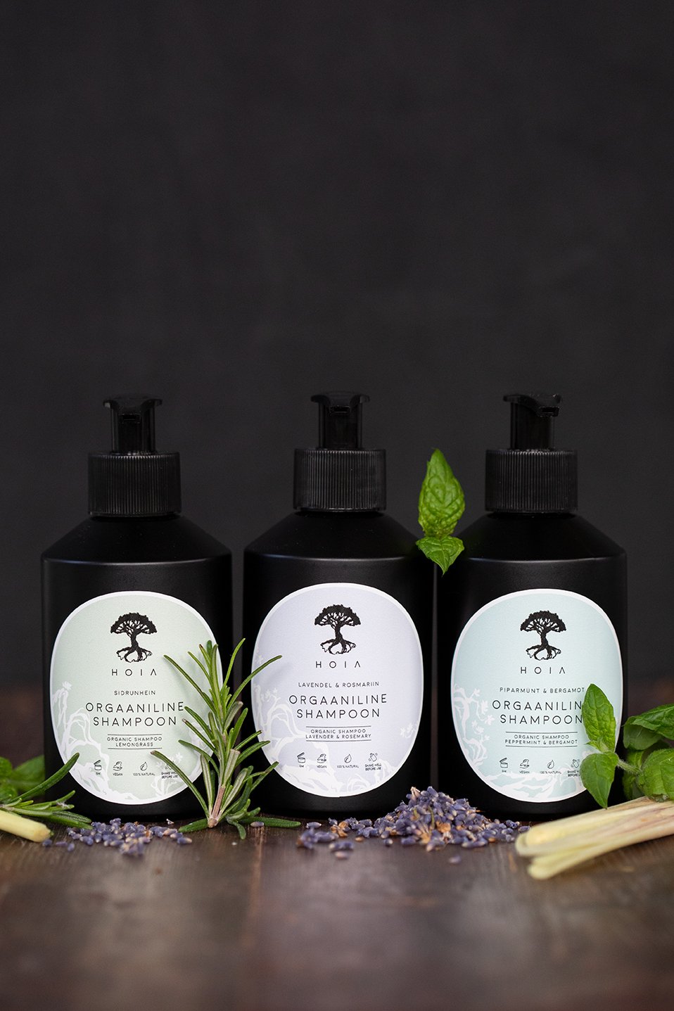 2. Trio of HOIA homespa Organic Shampoos including Peppermint & Bergamot, displayed with herbs and lavender