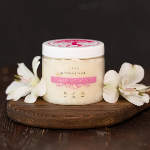 4. HOIA homespa Monoi de Tahiti Body Butter jar on wooden board with white flowers