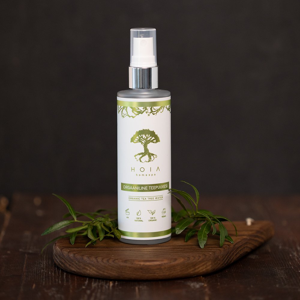1. HOIA homespa Organic Tea Tree Water 100ML bottle on wooden surface with green leaves, highlighting natural skincare