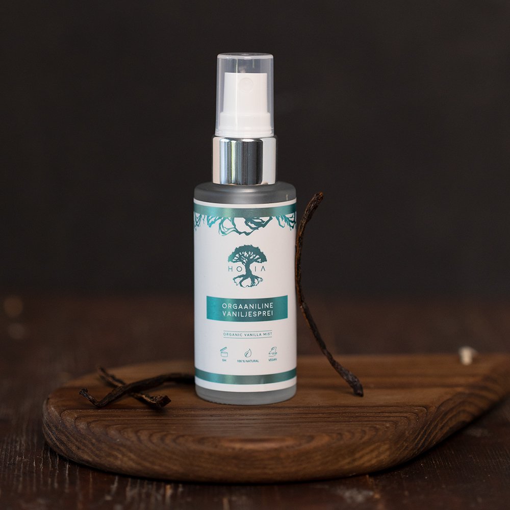 1. HOIA homespa Organic Vanilla Mist bottle on wooden board with vanilla pods, showcasing natural skincare product