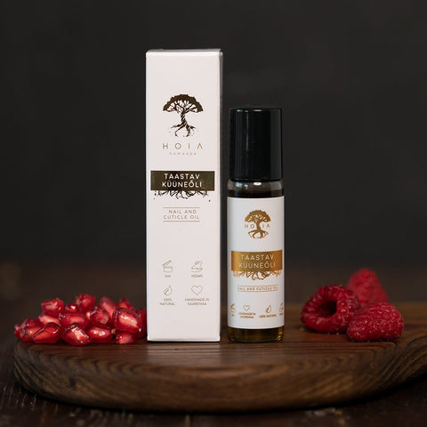 1. HOIA homespa Restorative Nail Oil 15ml with roller applicator, shown with packaging and fresh raspberries and pomegranate seeds, highlighting natural ingredients and vegan formula