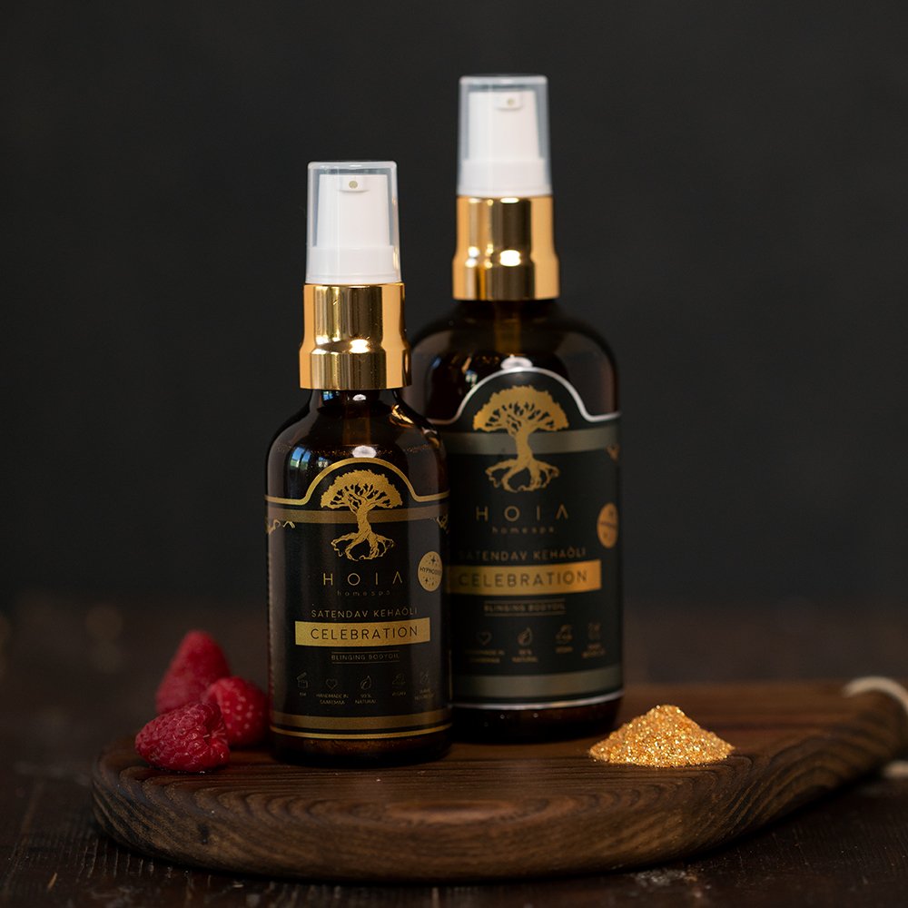 4. HOIA homespa Shimmering Body Oil bottles on wooden board with raspberries and mica, close-up