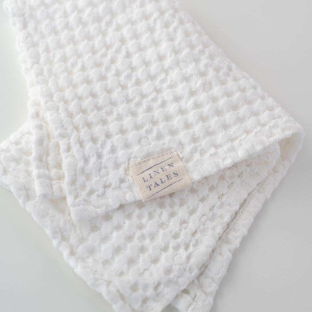 3. Close-up of Linen Tales label on white honeycomb waffle towel, highlighting brand detail