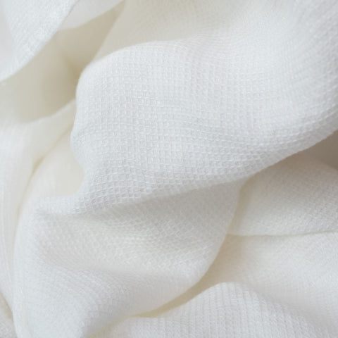 2. Close-up of white waffle linen fabric highlighting delicate texture and weave pattern