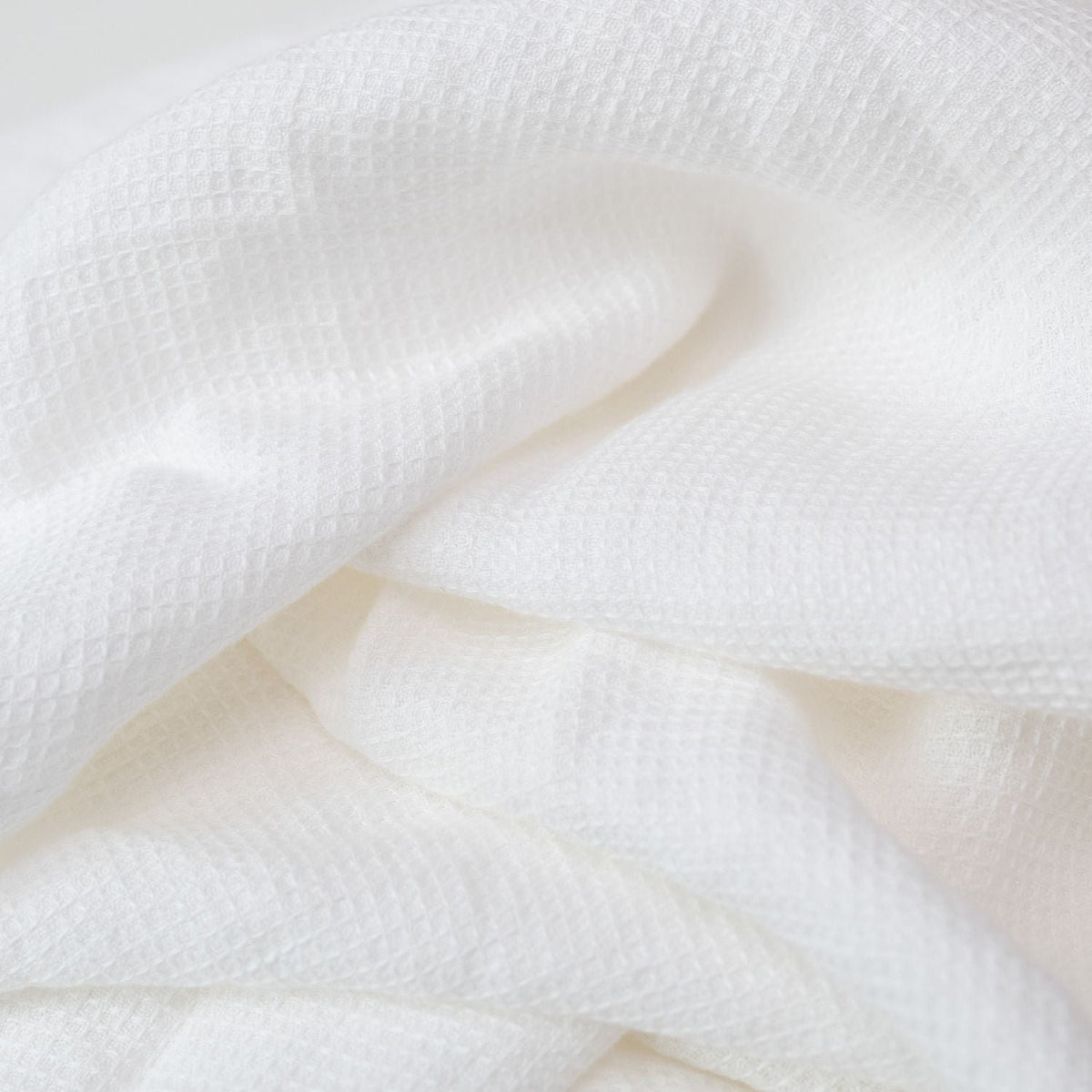 6. Close-up of white waffle linen fabric showing intricate weave and soft texture