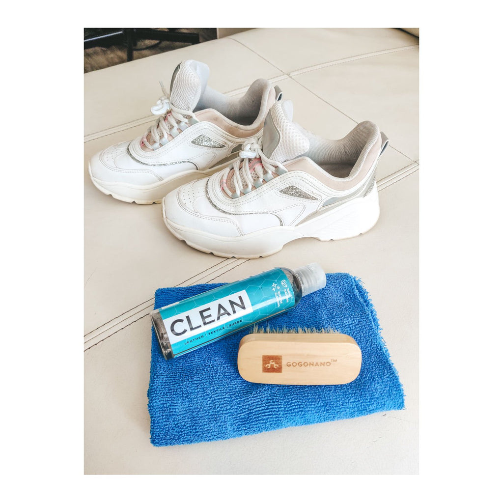 4. GoGoNano shoe cleaner gel with brush and cloth next to white sneakers on white surface
