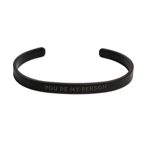 1. Men's matte black stainless steel bracelet by Olla with 'You're My Person' engraving, shown in studio