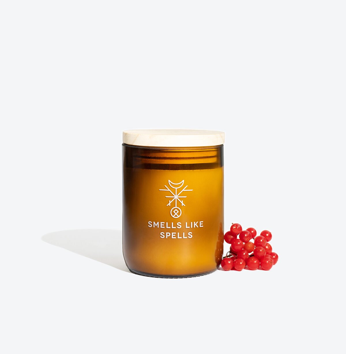 1. Smells Like Spells Scented Candle ODIN in amber glass jar with wooden lid, featuring red berries, handcrafted with soy wax and essential oils