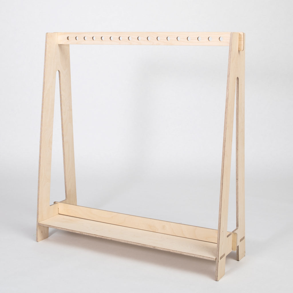 2. Natural wood toddler clothing rack with clean lines on a white background