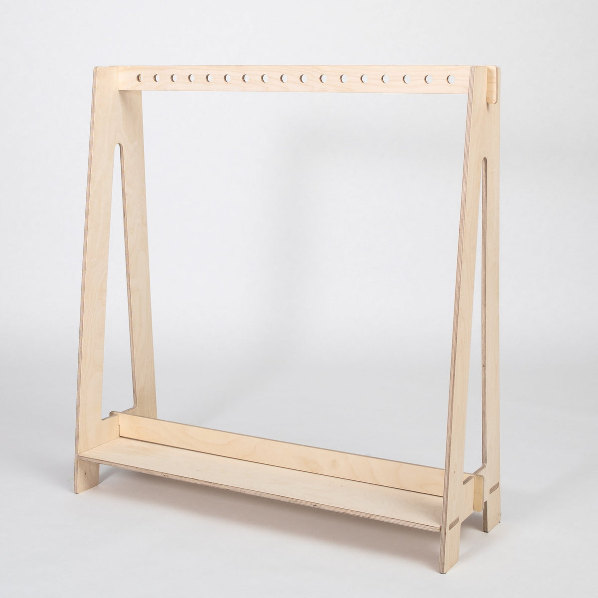 2. Natural wood toddler clothing rack with clean lines on a white background