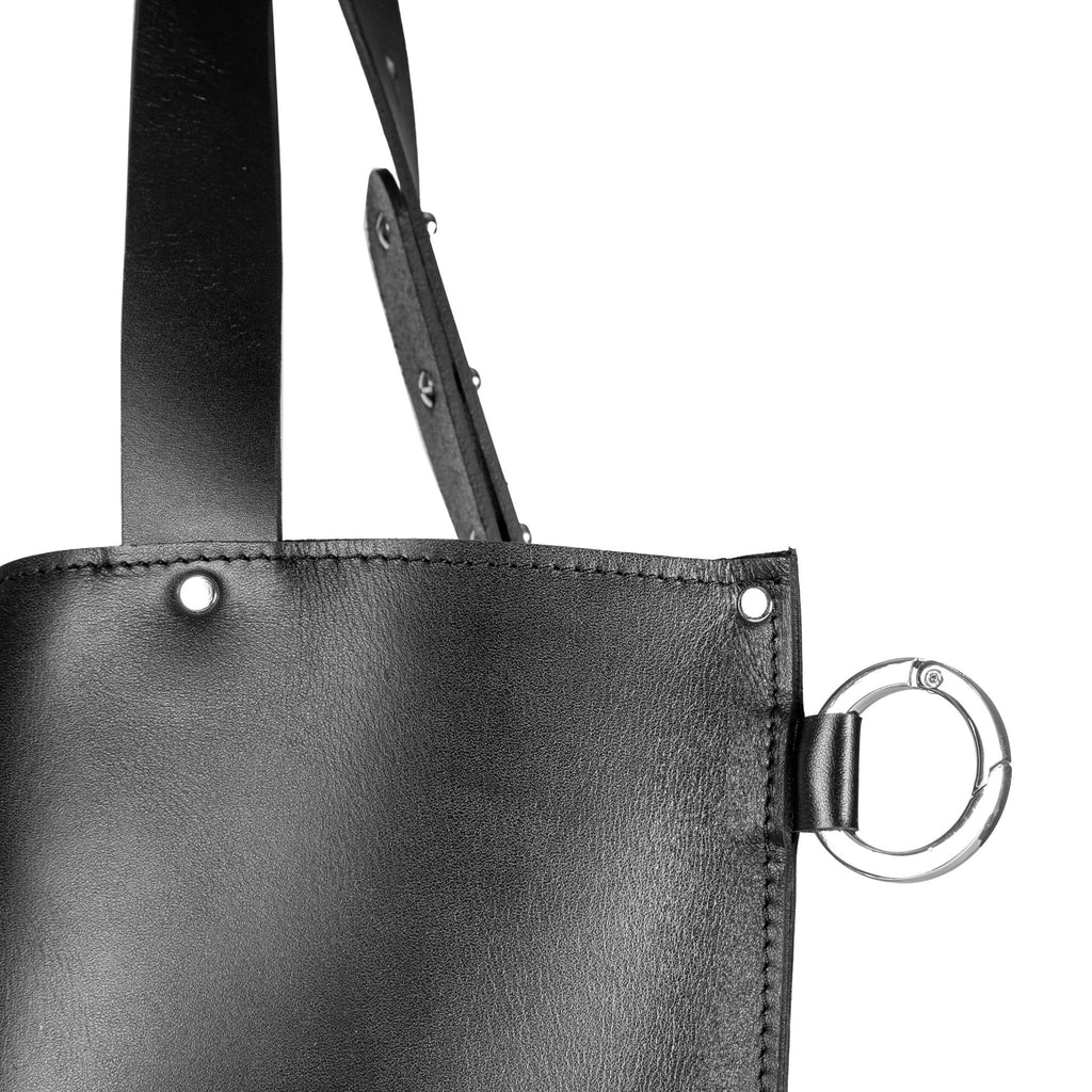 6. Close-up of PYKOK Adele handbag's black leather texture and metal ring detail