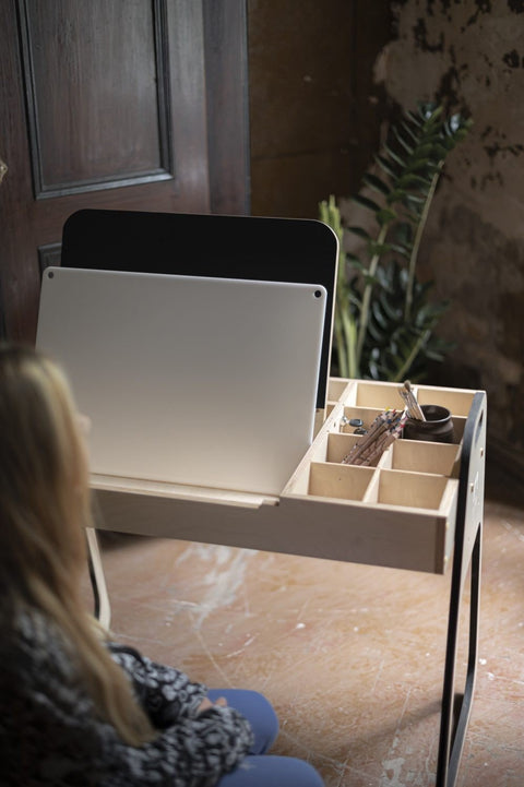 5. Child sitting at desk with LUULA acrylic whiteboard and storage compartments